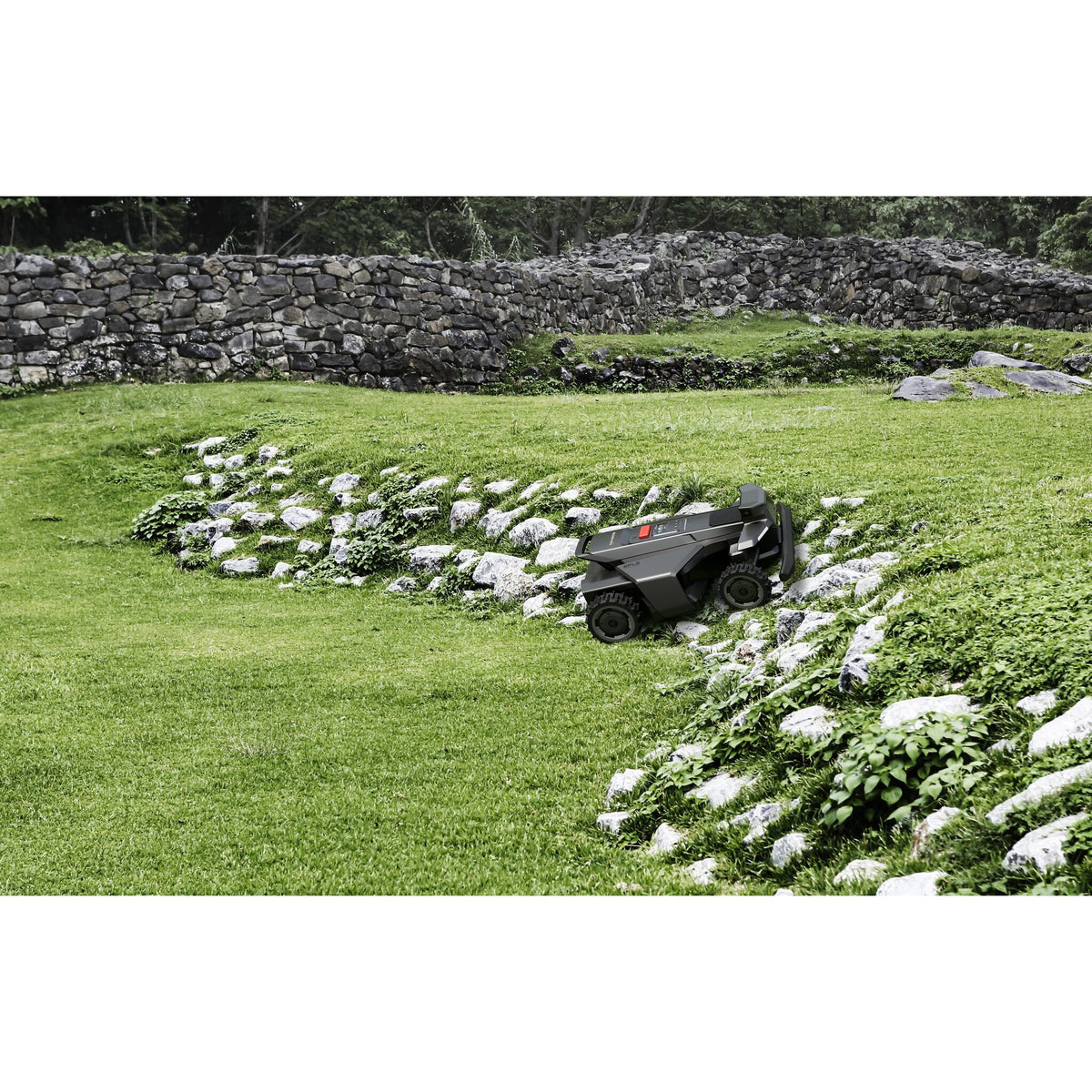 Navimow X4 robotic mower crossing a gravel path in the yard
